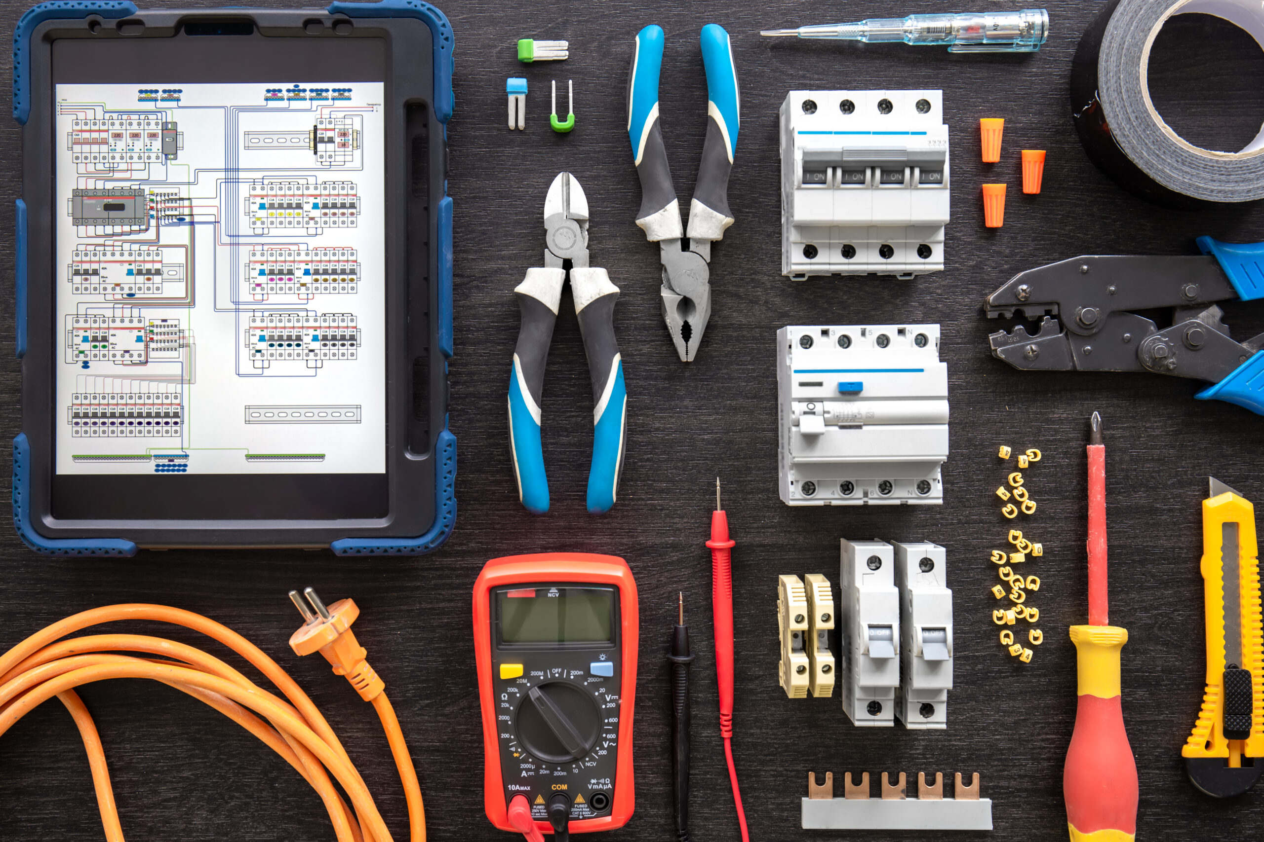 Different electrical tools on wooden background, flat lay